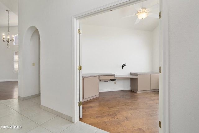 19102 N 91st St, Scottsdale, AZ 85255 - hallway featuring arched walkways, a chandelier, light wood-style flooring, and an office area