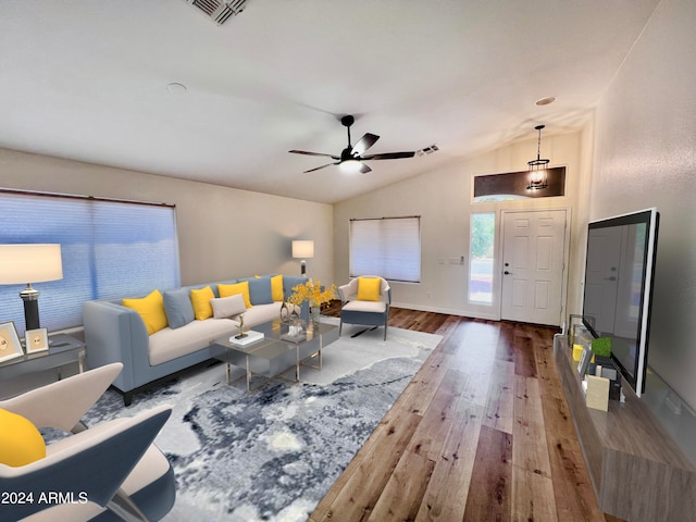 living room featuring lofted ceiling, hardwood / wood-style flooring, and ceiling fan