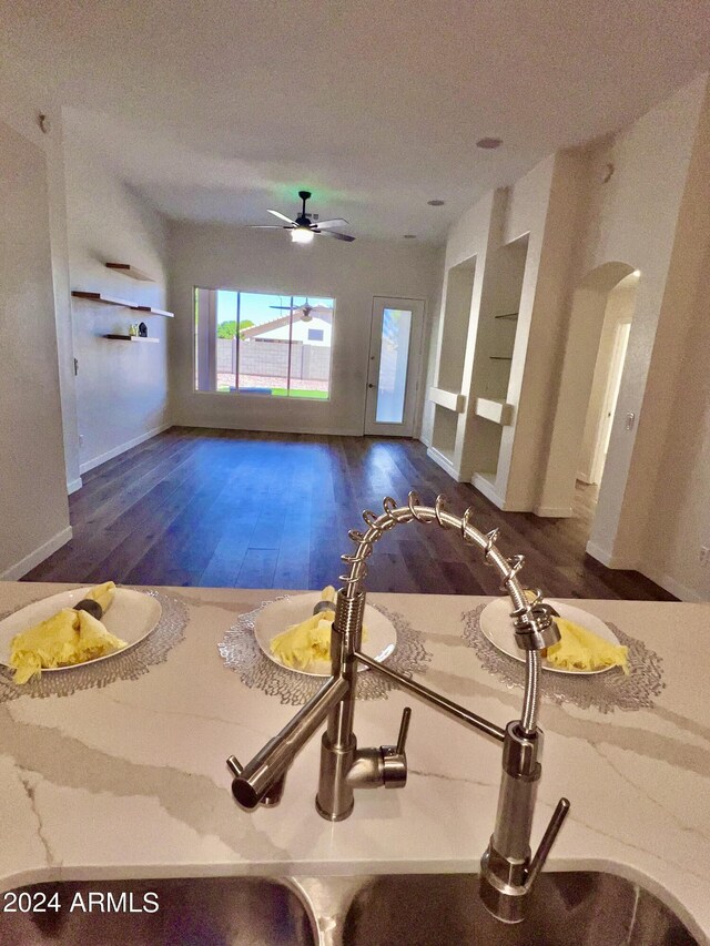 interior space featuring dark wood-type flooring, a textured ceiling, sink, and ceiling fan