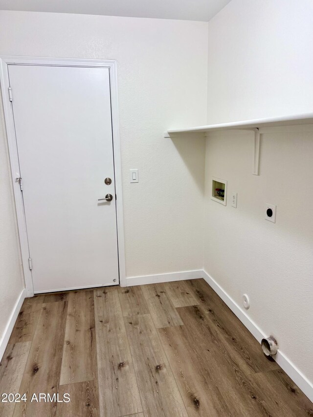 laundry area with washer hookup, light hardwood / wood-style flooring, electric dryer hookup, and hookup for a gas dryer