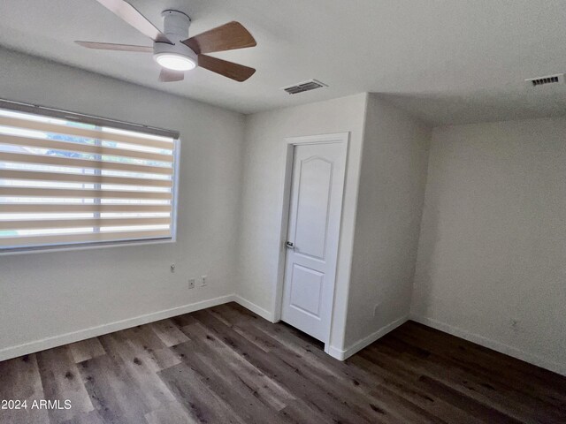 unfurnished bedroom with ceiling fan and dark hardwood / wood-style floors