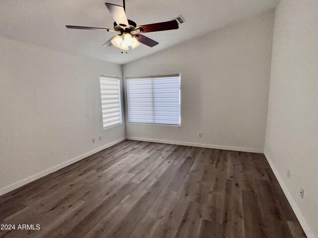 unfurnished room featuring ceiling fan, vaulted ceiling, and dark hardwood / wood-style flooring