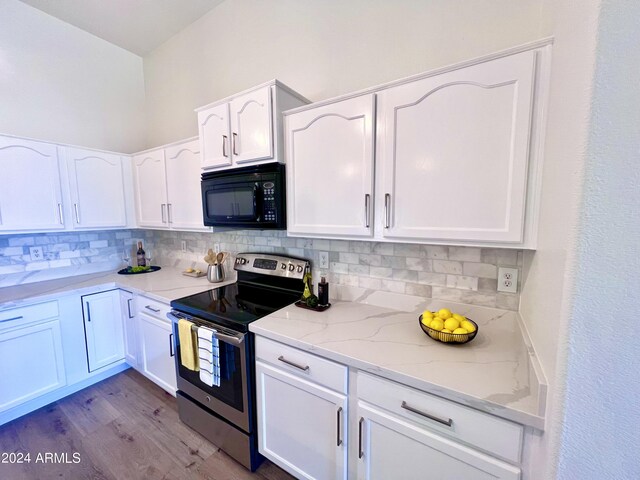 kitchen with electric range, backsplash, and white cabinetry