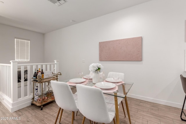 dining room featuring wood finished floors and baseboards