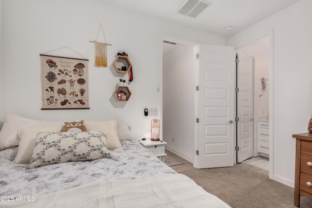 bedroom with light colored carpet and connected bathroom