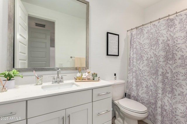 full bathroom with toilet, vanity, and a shower with shower curtain