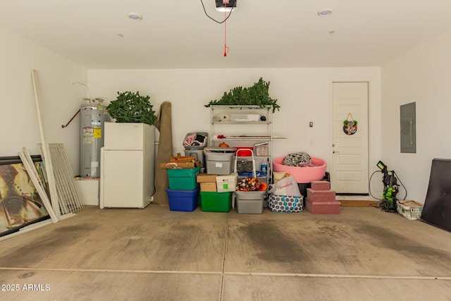 garage featuring freestanding refrigerator, water heater, and electric panel