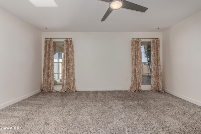 carpeted empty room featuring ceiling fan