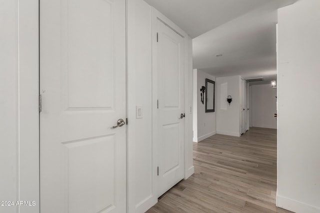 hall with light hardwood / wood-style floors