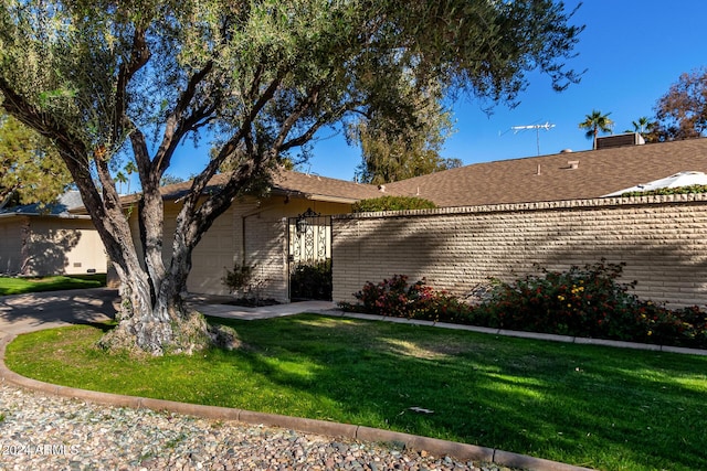 view of home's exterior featuring a lawn and a garage