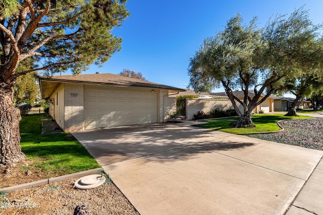 single story home featuring a front yard and a garage