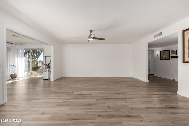 empty room with light hardwood / wood-style floors and ceiling fan