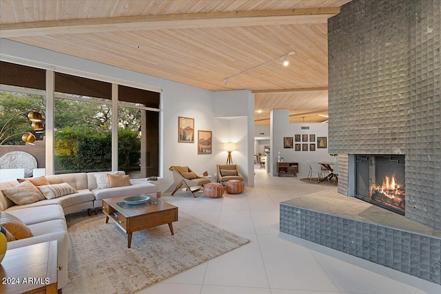 tiled living room featuring a brick fireplace, wooden ceiling, beam ceiling, and a towering ceiling