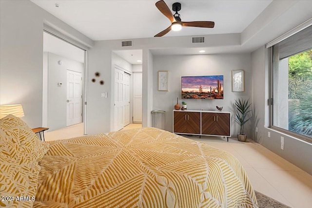 tiled bedroom with a closet and ceiling fan