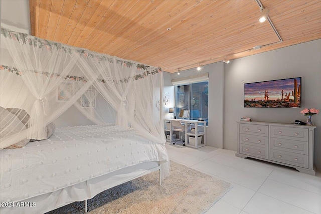 bedroom featuring wood ceiling, rail lighting, and light tile patterned floors