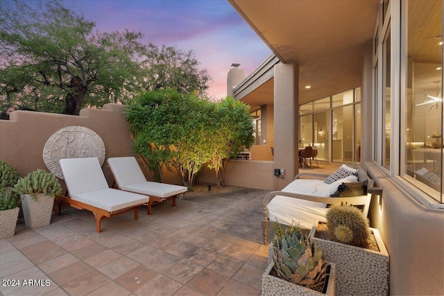 view of patio terrace at dusk