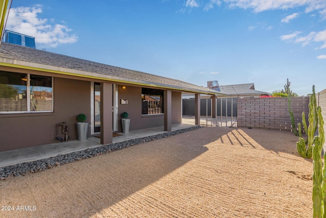 back of property with a patio