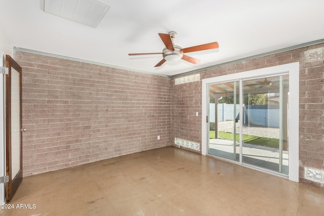 empty room featuring concrete flooring and brick wall