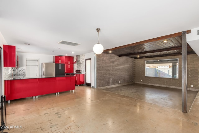 interior space with beam ceiling, sink, and brick wall