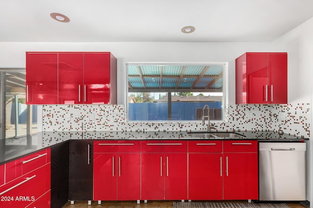 kitchen featuring dishwasher, sink, a wealth of natural light, and tasteful backsplash