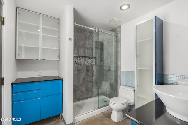bathroom with concrete floors, toilet, an enclosed shower, and sink