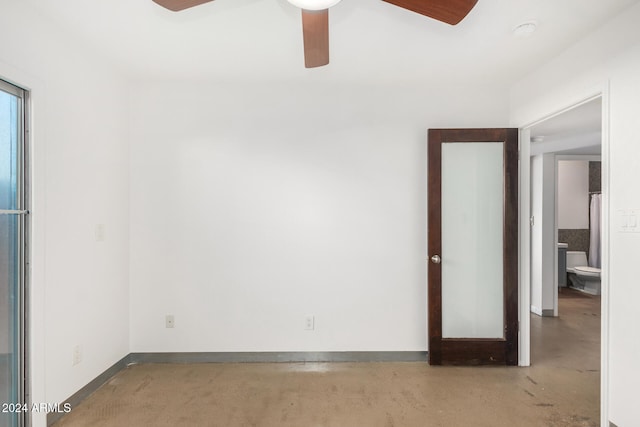 empty room featuring ceiling fan and concrete floors