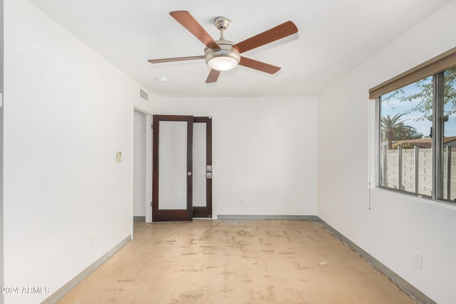carpeted empty room featuring ceiling fan