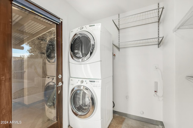 laundry room with stacked washer / drying machine
