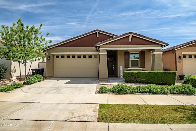 view of front of property featuring a garage, stucco siding, driveway, and a tile roof