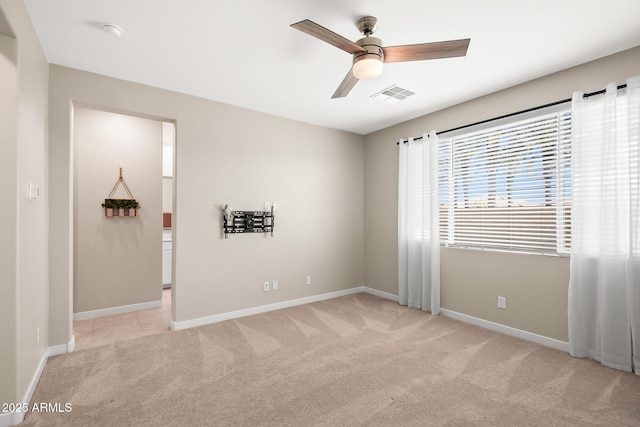unfurnished room featuring visible vents, baseboards, ceiling fan, and light colored carpet