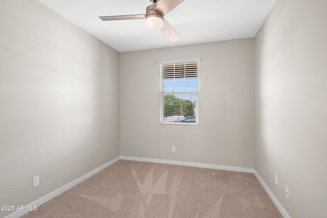empty room featuring carpet floors, ceiling fan, and baseboards