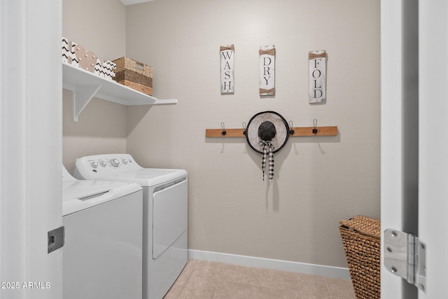 clothes washing area featuring baseboards, laundry area, washer and clothes dryer, and tile patterned floors