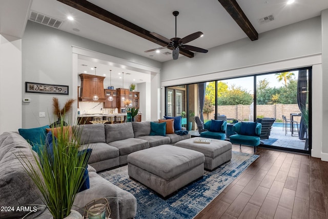 living room with ceiling fan, beam ceiling, and dark hardwood / wood-style floors