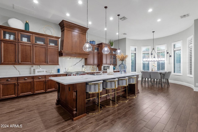 kitchen featuring hanging light fixtures, dark hardwood / wood-style floors, and tasteful backsplash