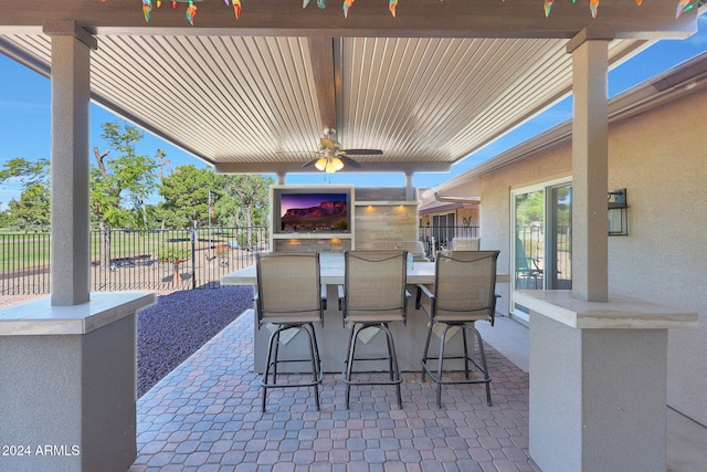 view of patio featuring ceiling fan and fence