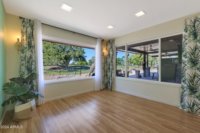 empty room with baseboards and wood finished floors