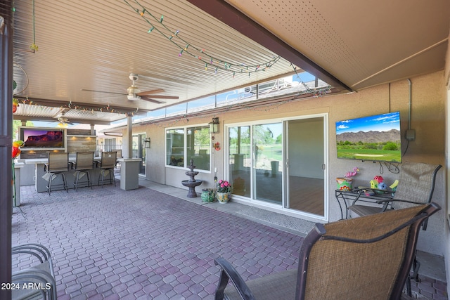 view of patio with ceiling fan and outdoor dry bar