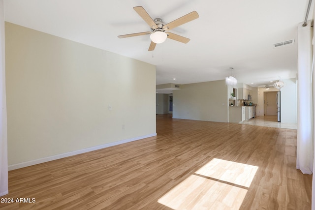 unfurnished living room featuring ceiling fan, baseboards, visible vents, and light wood-style floors