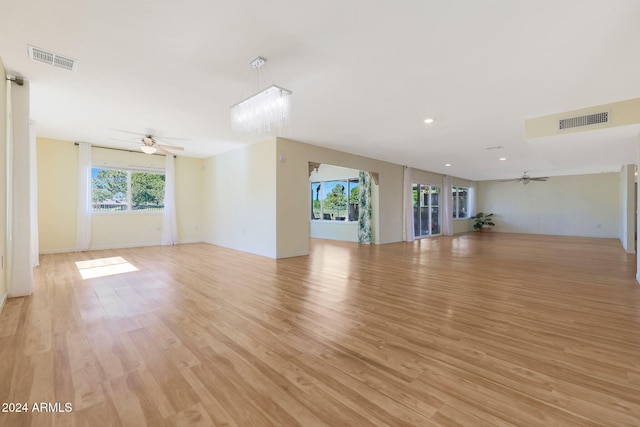 unfurnished living room with light wood finished floors, visible vents, a ceiling fan, and recessed lighting