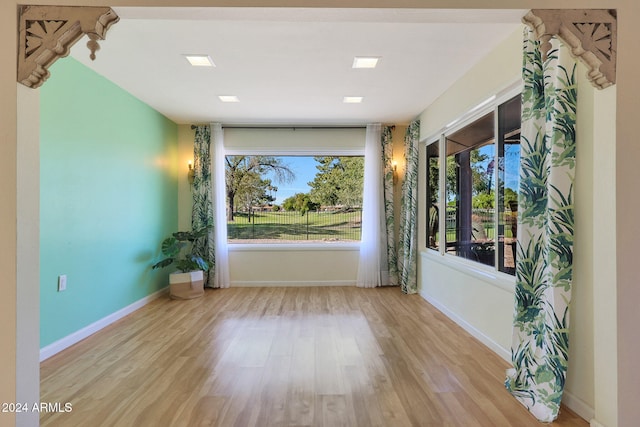 interior space featuring baseboards and wood finished floors