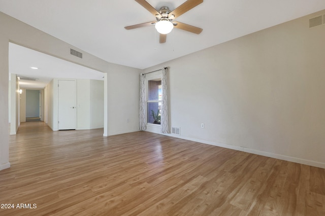 unfurnished room featuring light wood-type flooring, baseboards, and visible vents