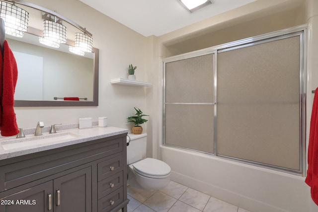 full bath featuring toilet, shower / bath combination with glass door, visible vents, vanity, and tile patterned floors