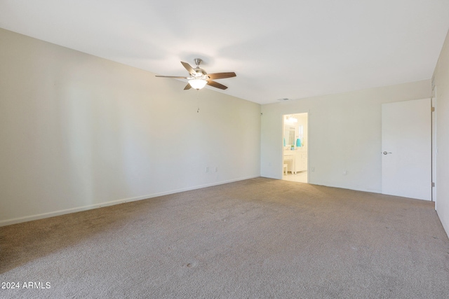 spare room featuring carpet floors and a ceiling fan