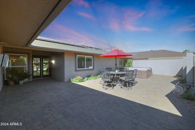 view of patio featuring a hot tub and outdoor dining area