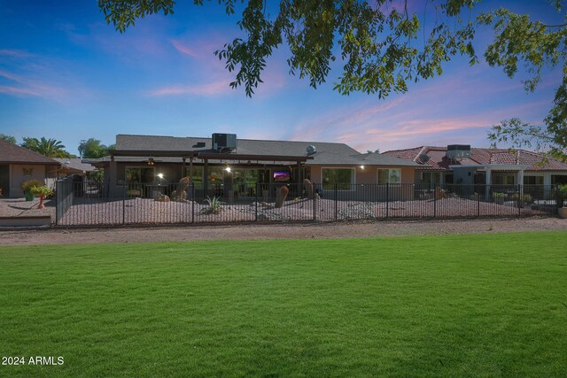 exterior space featuring a patio area, a yard, and fence