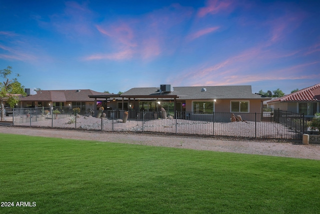 exterior space featuring fence and a lawn