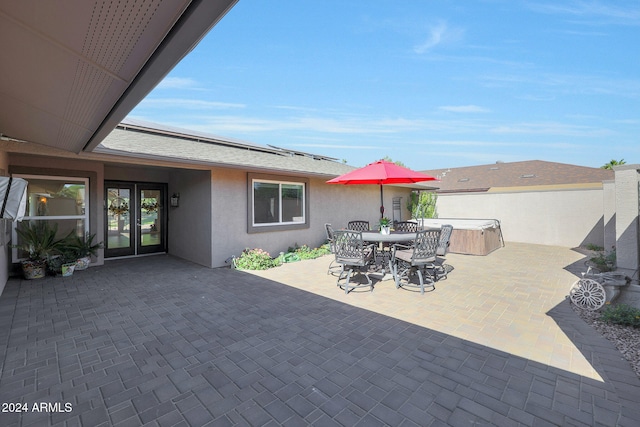 view of patio with outdoor dining area and a hot tub