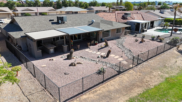 exterior space featuring a patio, cooling unit, a fenced backyard, and a residential view