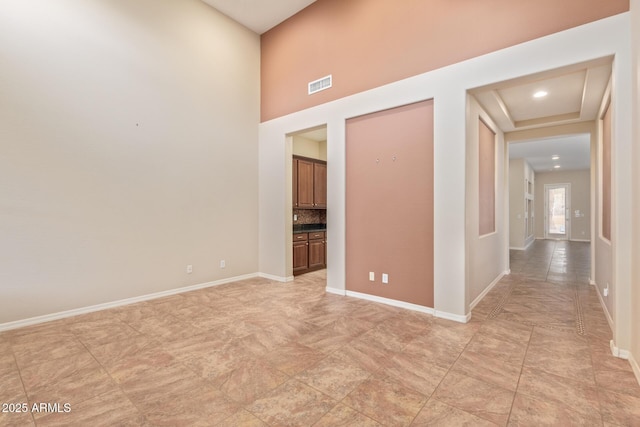 empty room with visible vents and baseboards