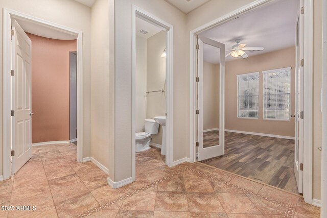 corridor featuring visible vents and baseboards